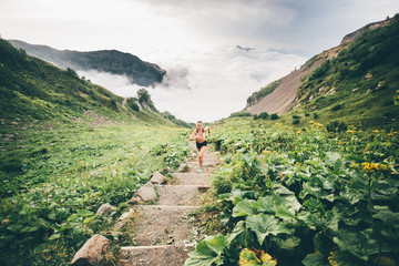 Woman running and jogging in the nature mountain scenery. Concept of healthy lifestyle. Fitness...