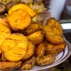 Close-up fried potatoes lying on a plate. Background from fried potatoes.