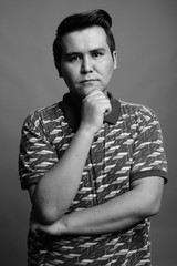 Young multi ethnic man against gray background