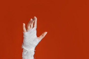 Halloween, costume image. The mummy's hand in bandages making gestures