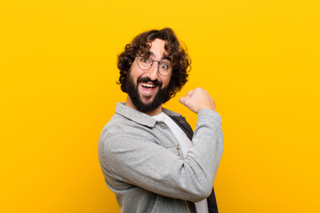 young crazy man feeling happy, positive and successful, motivated when facing a challenge or...