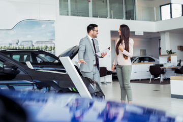 Customer buying a vehicle at car dealership - obrazy, fototapety, plakaty
