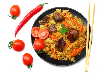 pilaf with meat and chili pepper on black plate isolated on white background. top view