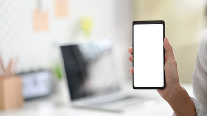 Closeup Young woman's hands holding blank screen of smartphone.