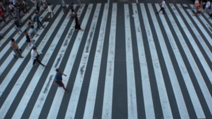 JAPAN : Aerial blurred high angle view of zebra crossing near Osaka train station. Crowd of people at the street. Shot in busy rush hour.