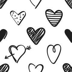 Seamless pattern with black hand drawn hearts on white background