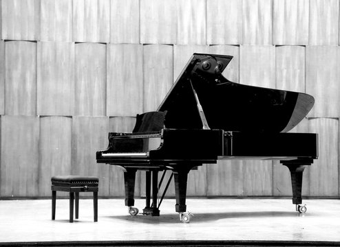 Grand piano set on stage, B&W