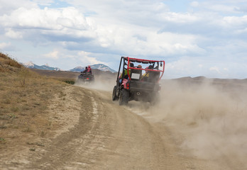 Buggy moves on a dirt dusty road