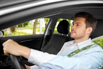 transport, vehicle and people concept - man or driver driving car in summer