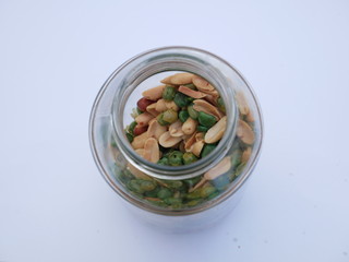 peas on white background, nut and beans in a glass jar