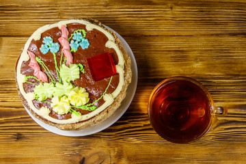 Cup of tea and Kiev cake on a wooden table. Top view