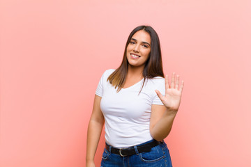 young pretty hispanic woman feeling confused, clueless and unsure, weighting the good and bad in...