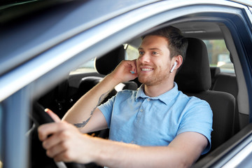 transport, vehicle and people concept - man or driver with wireless earphones or hands free device...