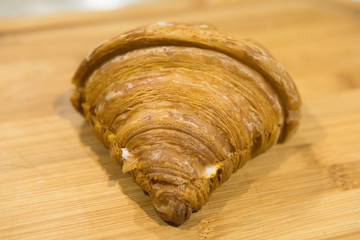 Croissant on wooden background