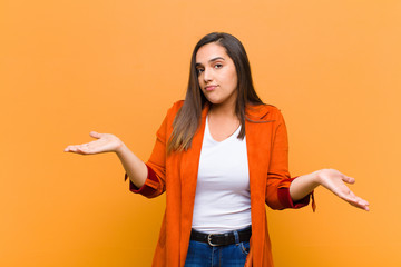 young pretty woman feeling puzzled and confused, unsure about the correct answer or decision,...