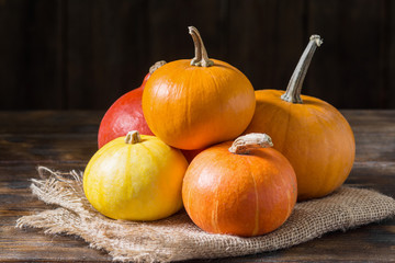 Pumpkins on a wooden table. The concept of the fall harvest