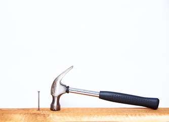 Hammer and construction nails on isolated white background close-up. With place under the text.