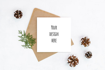 Flat lay Christmas greeting card craft paper envelope decoration minimal composition pinecones on...