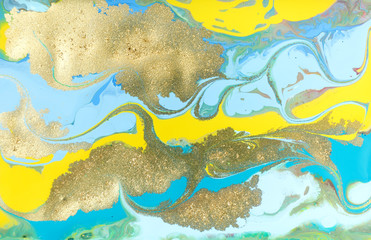 Fototapeta na wymiar Yellow and blue pastel marble pattern with golden glitter. Abstract liquid background.