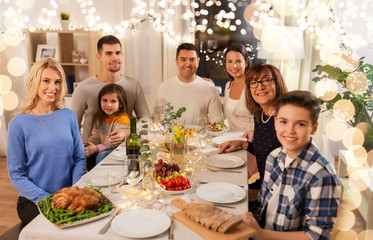 celebration, holidays and people concept - happy family having dinner party at home