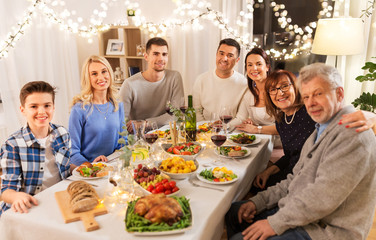 celebration, holidays and people concept - happy family having dinner party at home