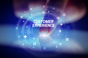 Finger touching tablet with social media icons and CUSTOMER EXPERIENCE