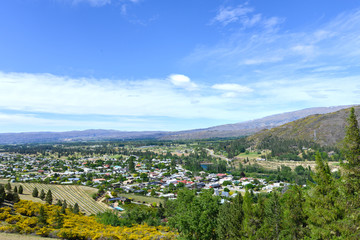 Naklejka na ściany i meble Big city in the midst of smashing the mountains in the New Zealand