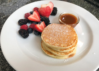 Close up of pan cake with mix berry in the white dish
