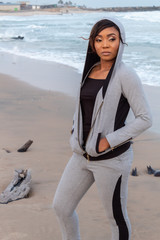 Lady in a hoodie by the beach