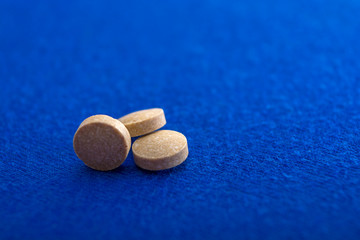 Medical pills close-up. Color capsules medication. Blue background. Health care concept. Free space for text. Medicines. Different pills. Chemical industry.