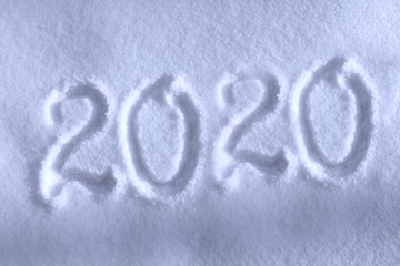 Abstract Christmas photo for beautiful Christmas card with background inscription 2020 on real white snow in winter in cold weather