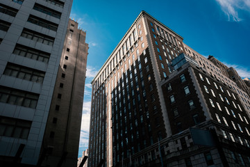 Naklejka premium skyscrapers in the city manhattan new york hotel real estate urban exploration discover walking sign rooms apartment rental leasing architecture building