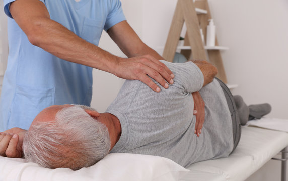 Chiropractic / Osteopathy treatment, Back pain relief. Physiotherapy for senior male patient, sport injury recovery , Kinesiology