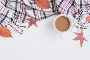 Cup of coffee and dried autumn leaves and scarf, Top view