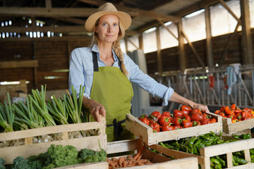 Cheerful farmer woman selling products directly fom the farm