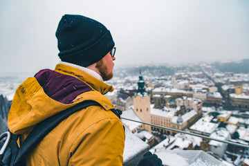 man looking at landscape view of old european city