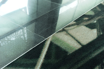 aluminum threshold between tiles and carpet in a public area