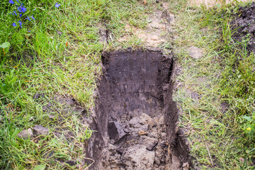 Obraz premium Drainage ditch. Laying a drainage pipe. Earthwork.