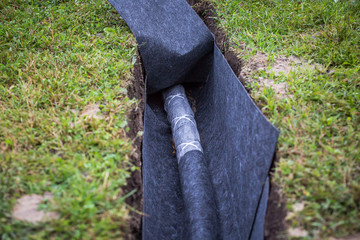 Drainage ditch. Laying a drainage pipe. Earthwork.
