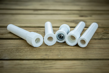 Polypropylene pvc plumbing pipes and fittings in the background of a wooden surface
