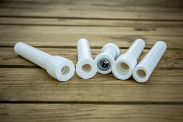 Polypropylene pvc plumbing pipes and fittings in the background of a wooden surface