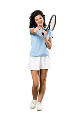 A full-length shot of a Young tennis player woman with thumbs up because something good has happened over isolated white background