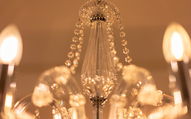 Blurred Background Chrystal chandelier lamp on the ceiling in Dining room Adjusting the image in a Luxury tone . Decorative elegant vintage and Contemporary interior Concept.