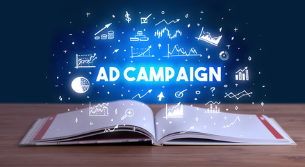AD CAMPAIGN inscription coming out from an open book, business concept
