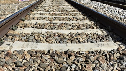 Close-up of the ballast and the sleepers of the train tracks
