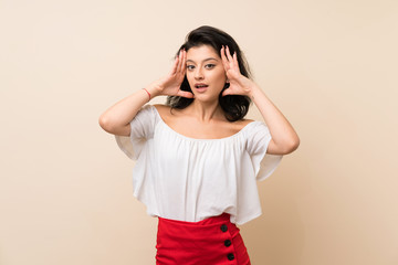 Young woman over isolated background with surprise expression