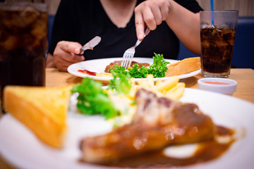 Enjoy eating steak in restaurant
