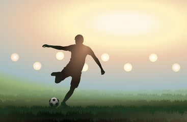 Fototapeta na wymiar Soccer player is kicking a ball in stadium at sunset.