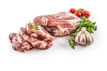 Pork neck raw meat with garlic parsley herbs tomatoes and rosemary isolated on white background