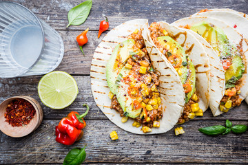 Mexican tacos with meat, beans corn and salsa. Top view